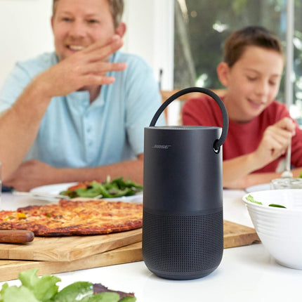 Bose speaker on a table with people in the background